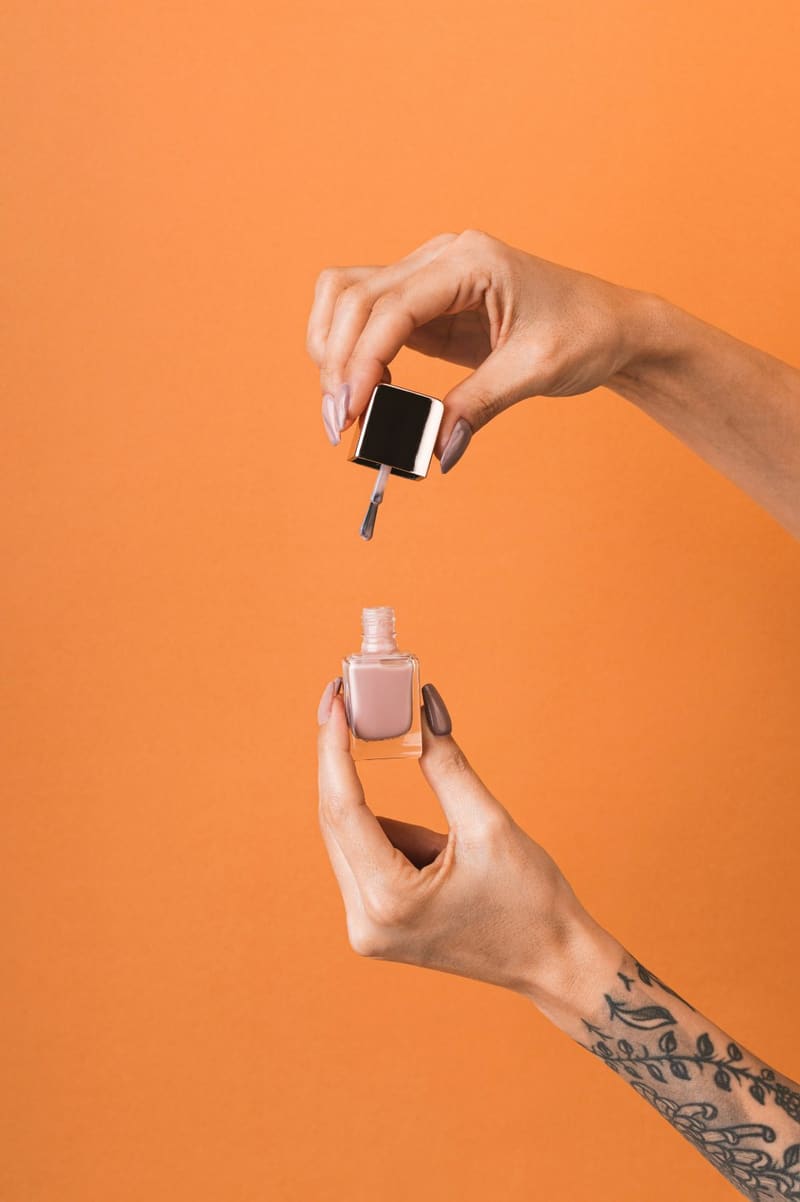 hands holding a bottle of nail polish