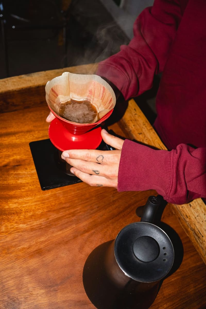 hands pouring a filter coffee