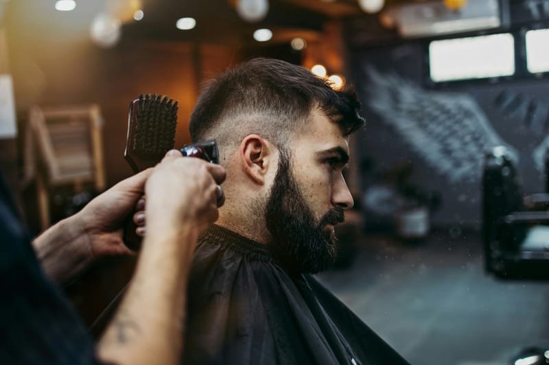 a man having a fade cut