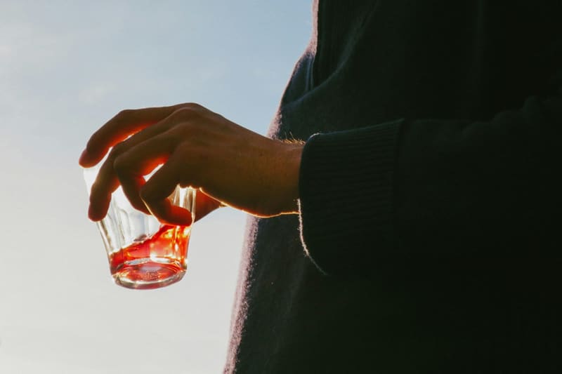 a hand setting down an empty glass