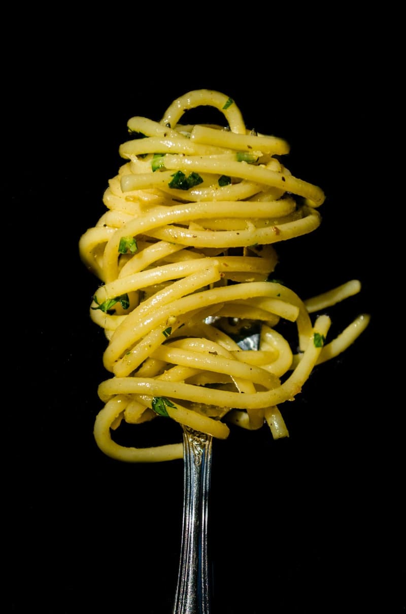 spaghetti with parsley on a fork