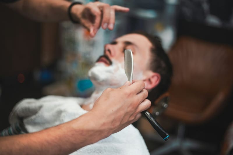 a cut throat shave in a barber chair