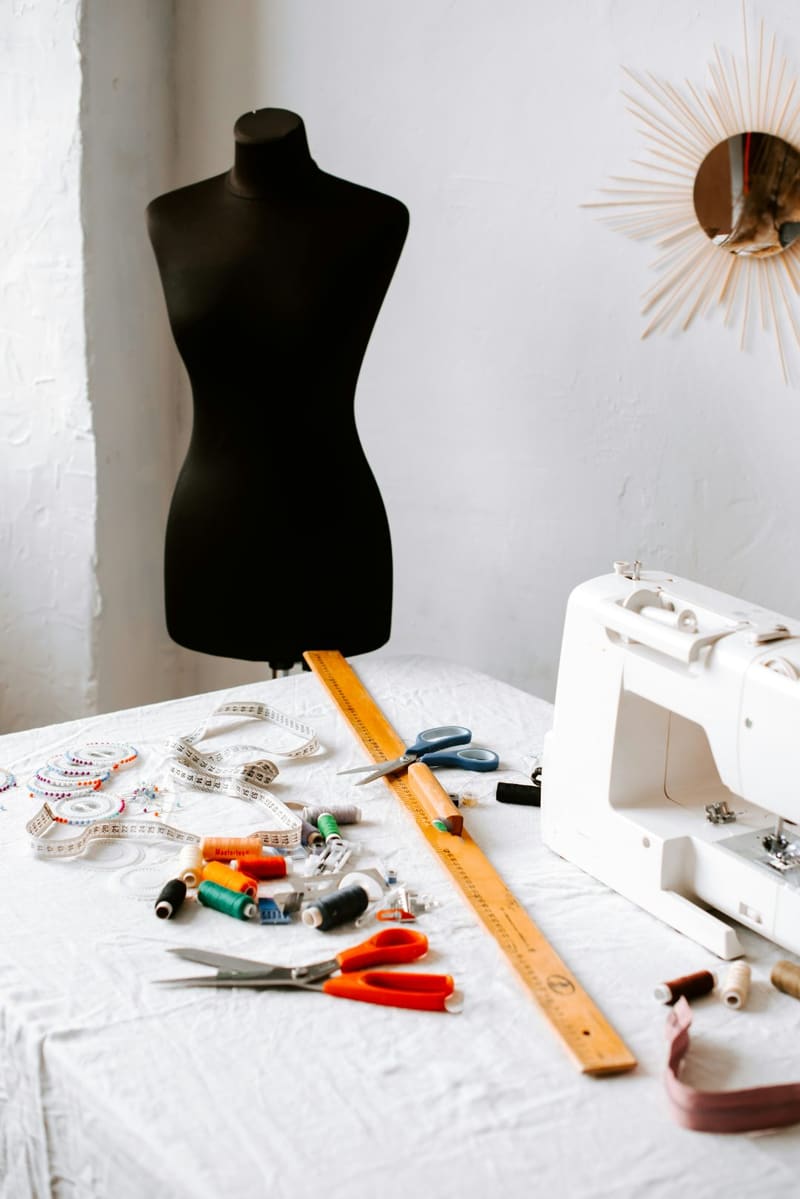 a sewing table with a dress form