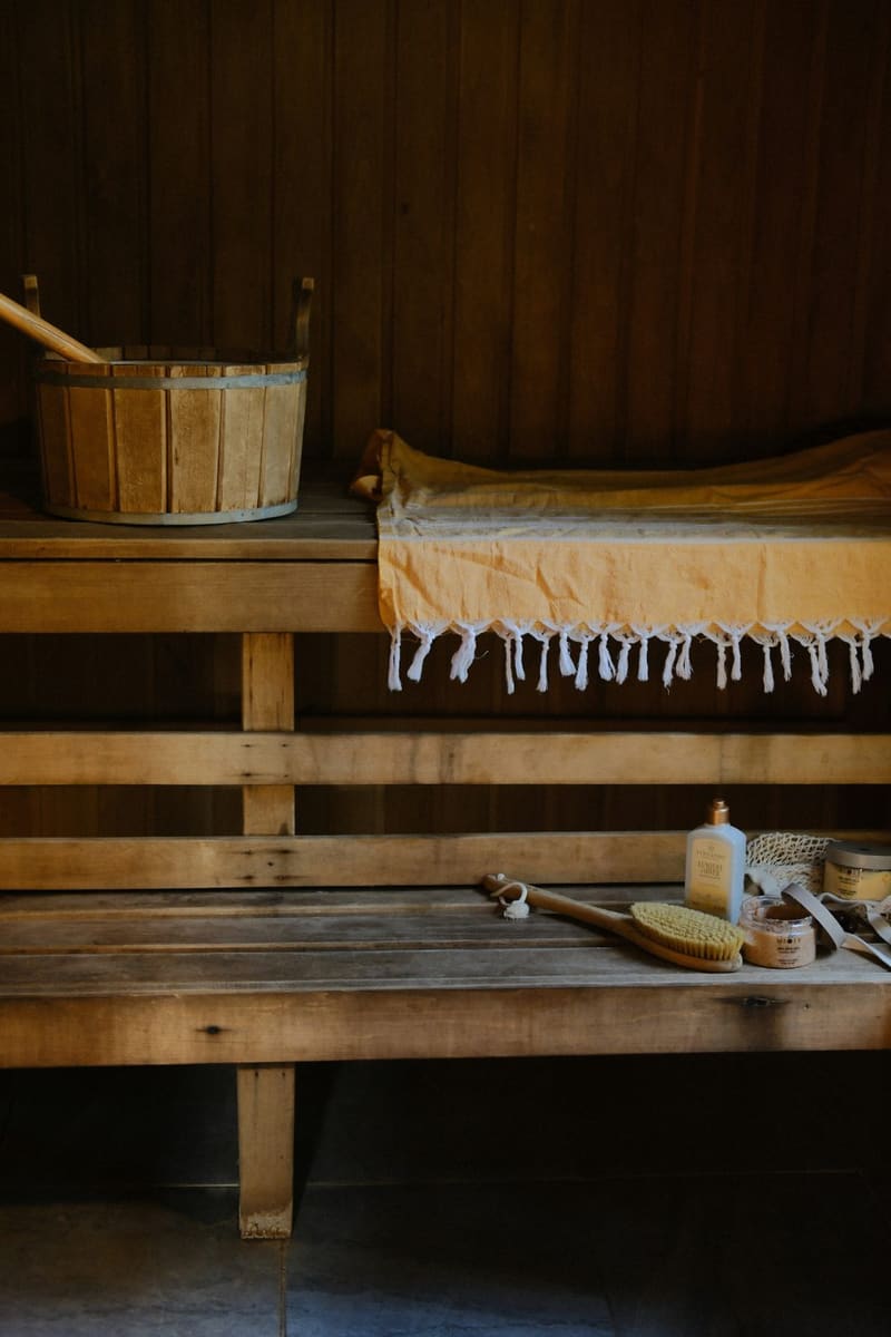 a sauna bench with a towel and brush
