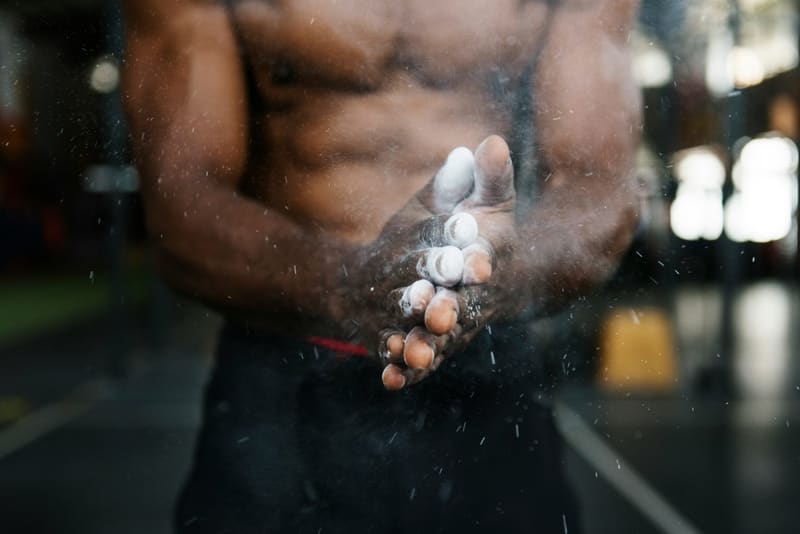 hands clapping chalk in a gym