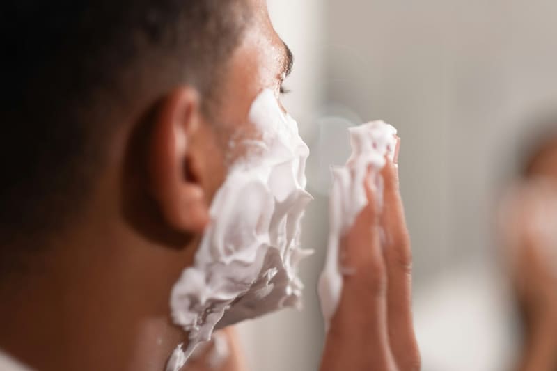 a man lathering shaving foam
