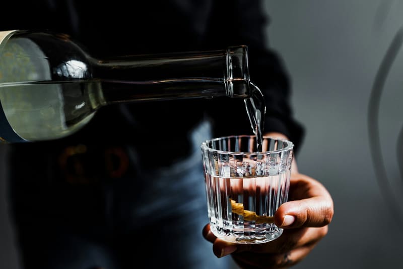 pouring a spirit over ice