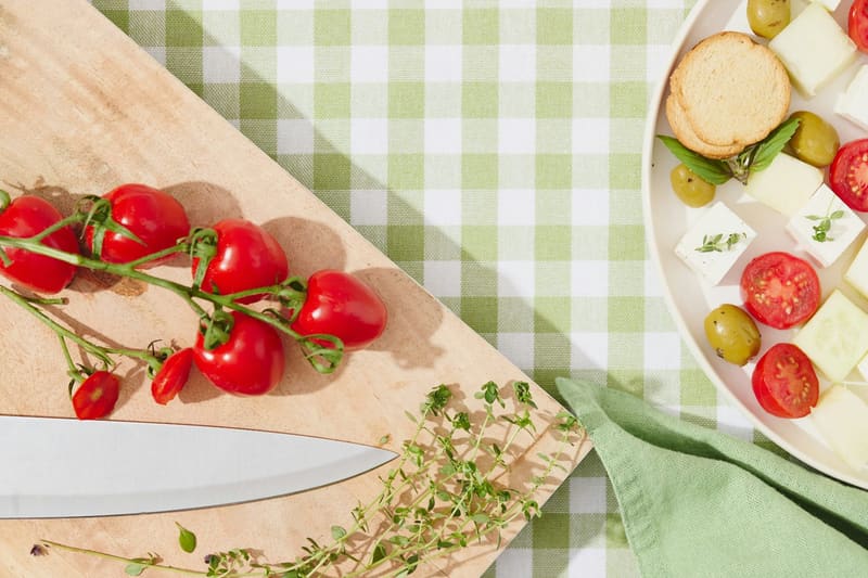 tomatoes and thyme on a board