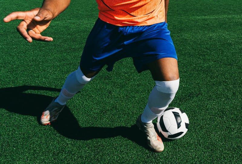a footballer with a ball on turf