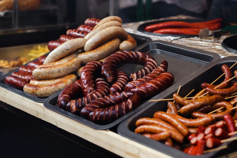 trays of sausages at a counter