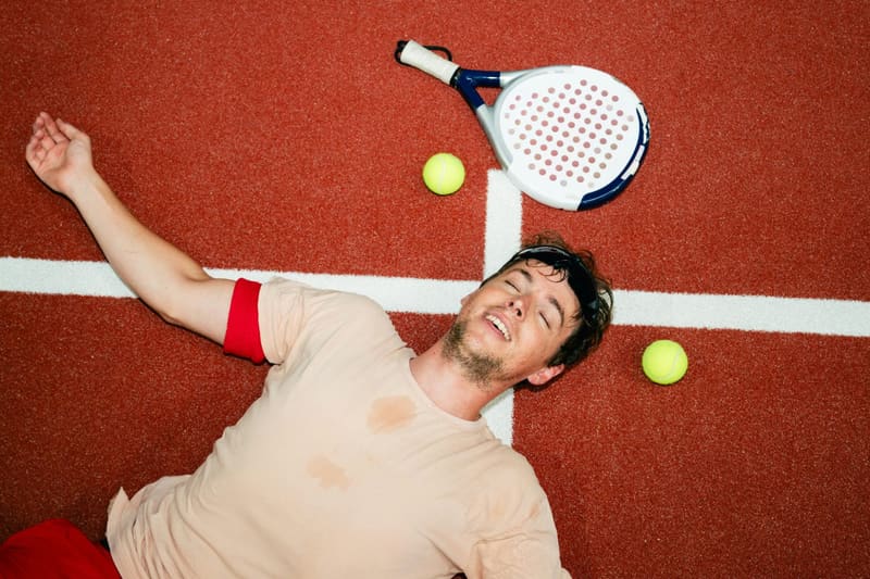 a padel player lying on the court