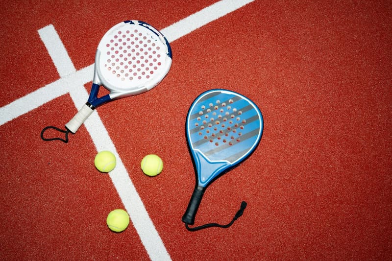 two padel rackets and three balls