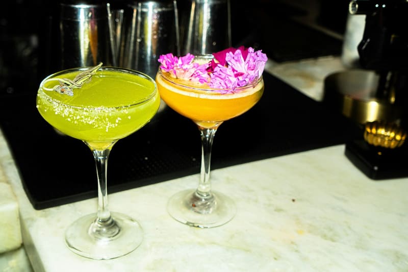 two cocktails with edible flowers