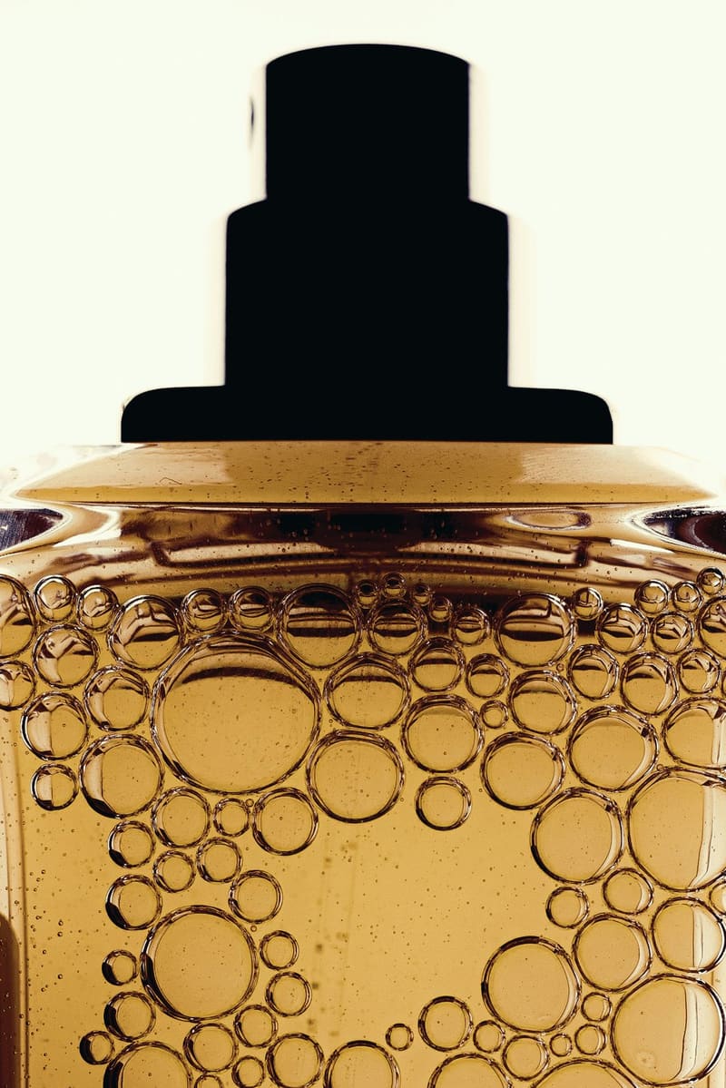 a bottle of golden oil with bubbles