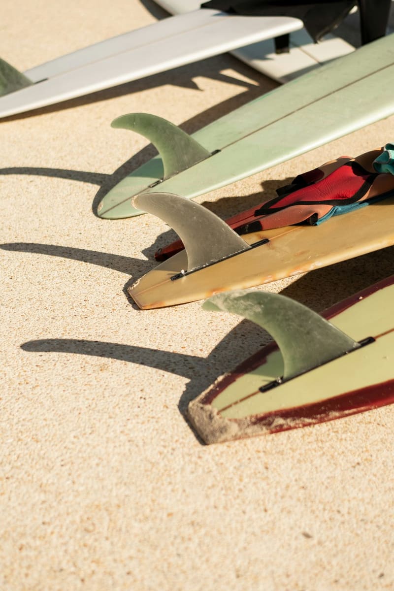 surfboard fins on the sand
