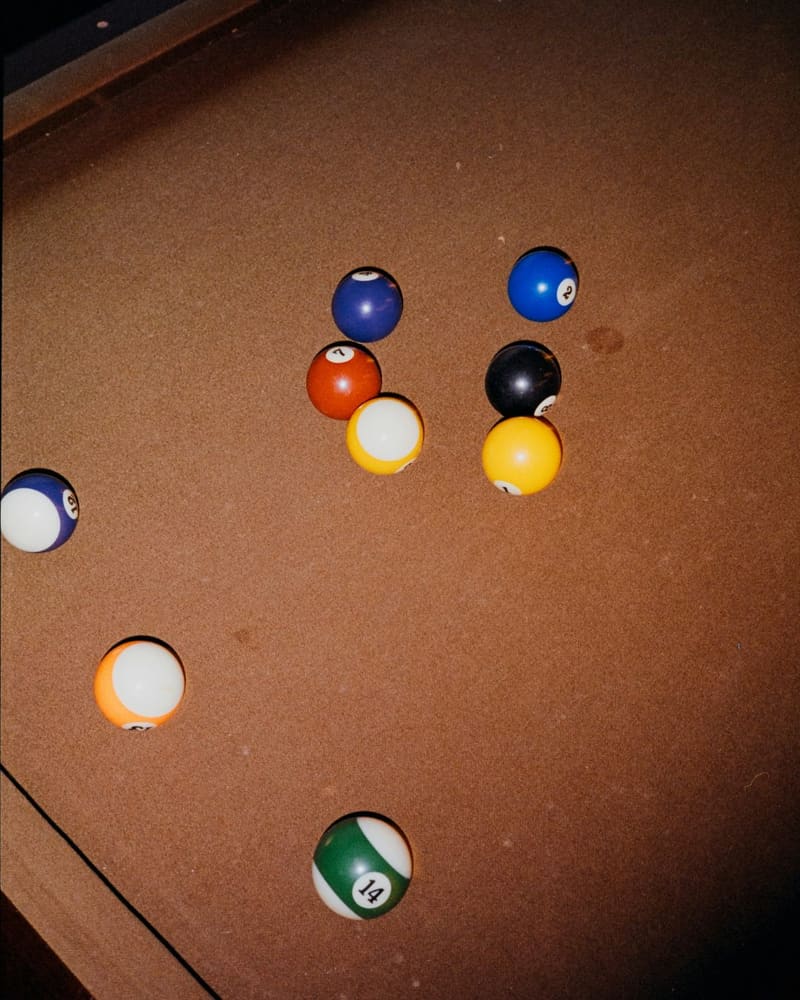 pool balls on a brown baize