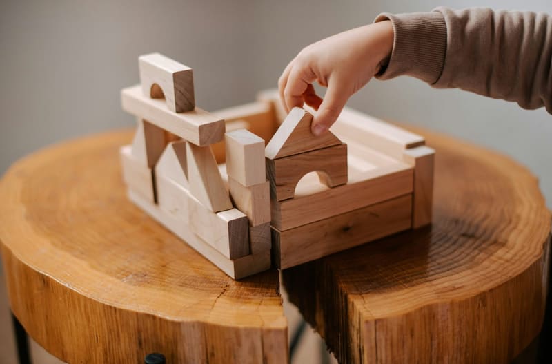 a child building with wooden blocks