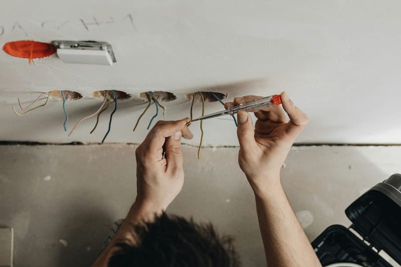 hands wiring a ceiling connector