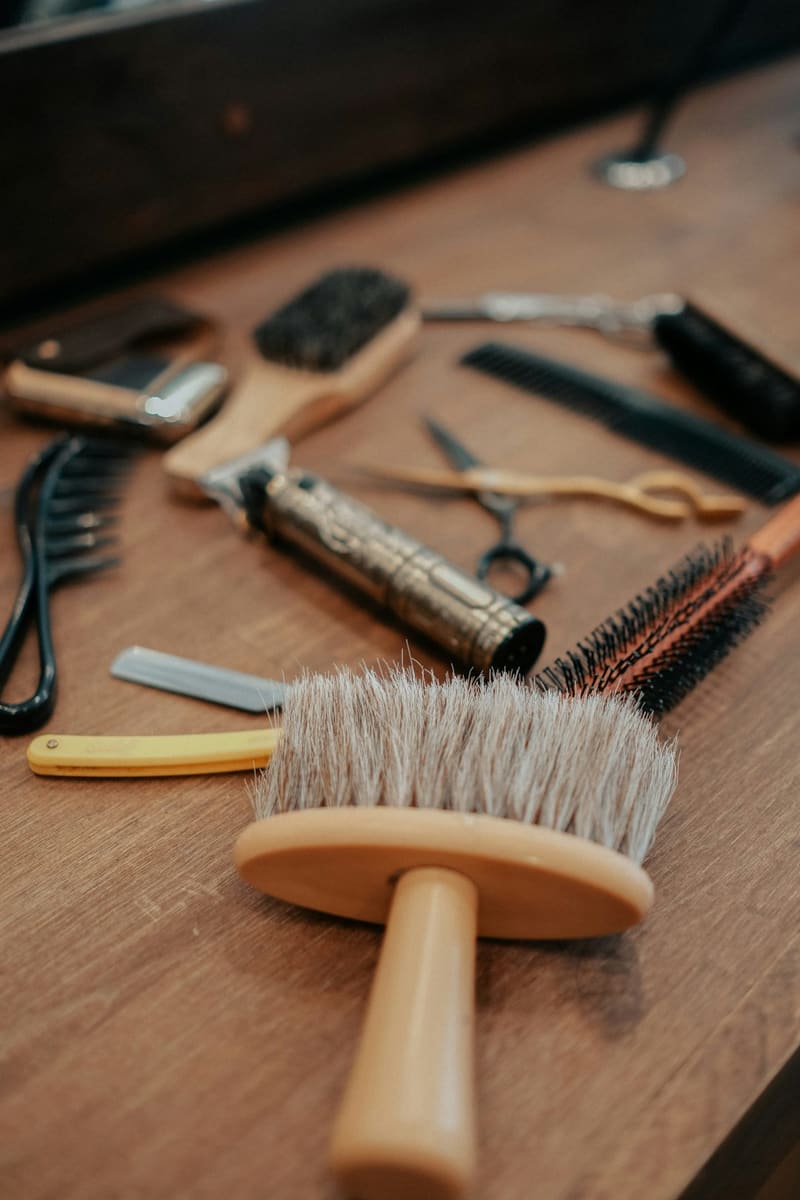 barber tools laid on a wooden bench