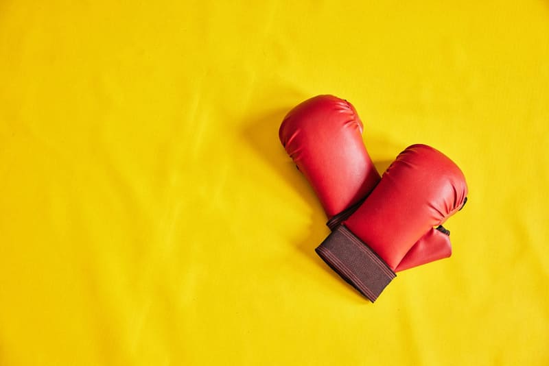 red boxing gloves on yellow