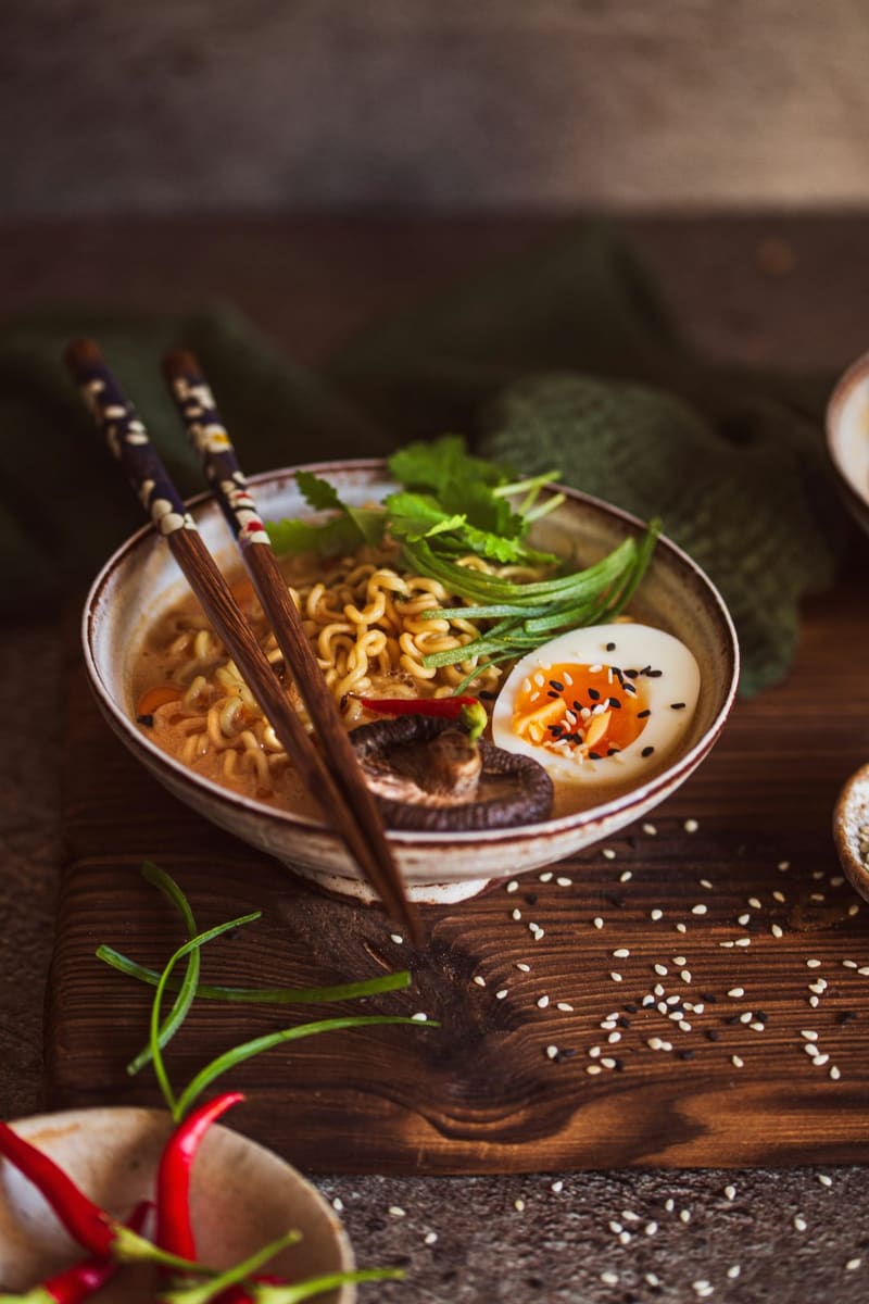 a bowl of ramen on a wooden table