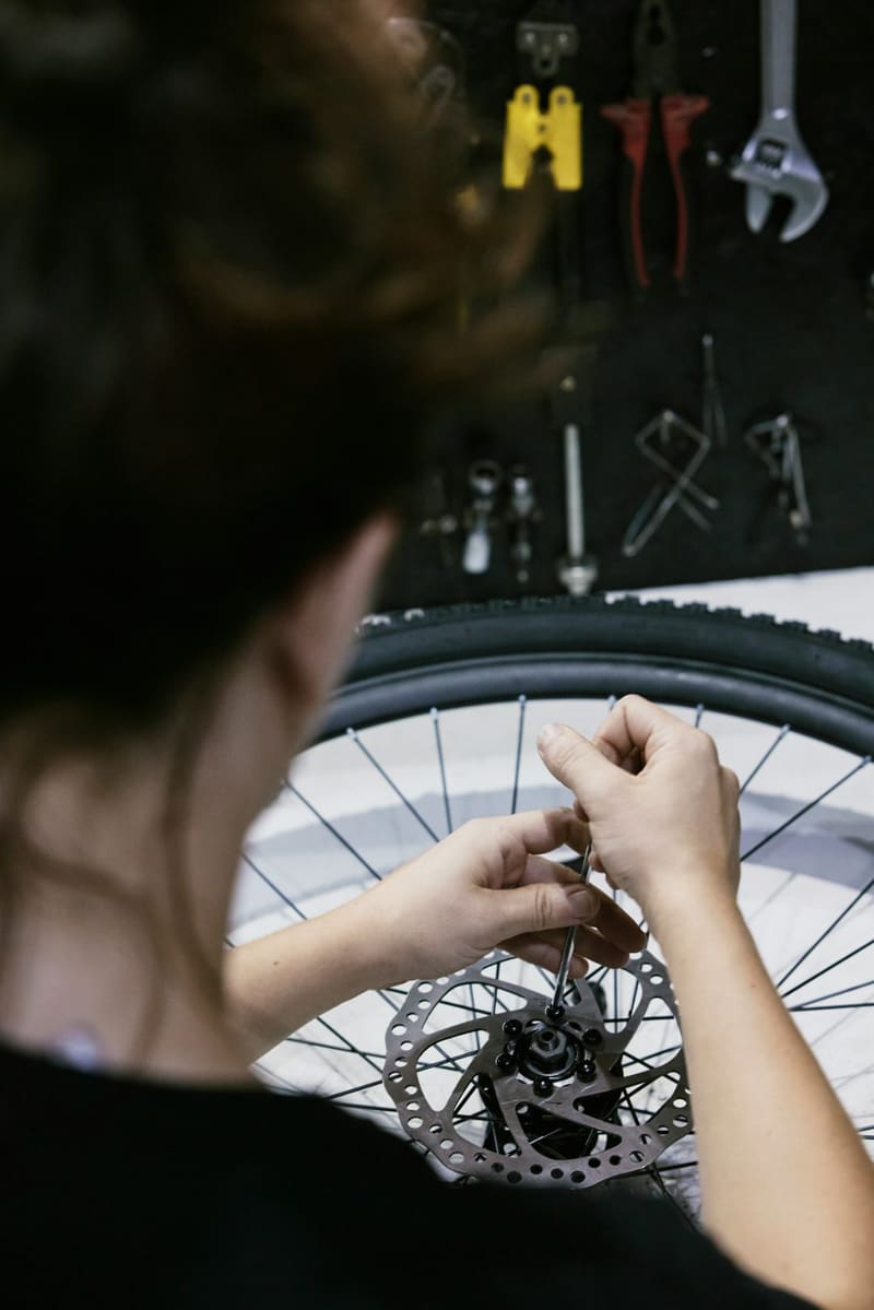 hands truing a bicycle wheel