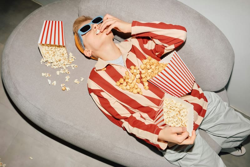 a woman lying with popcorn boxes