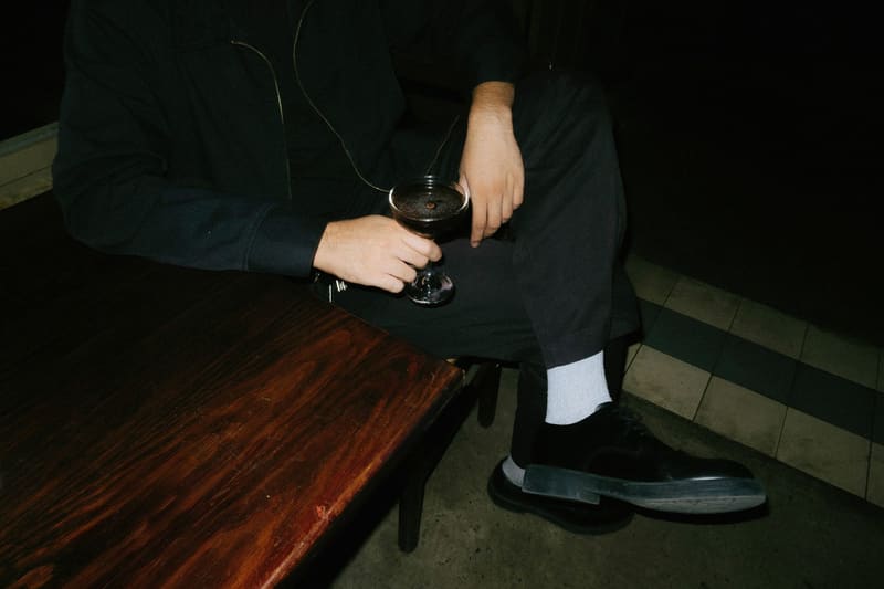 a seated man with a cocktail
