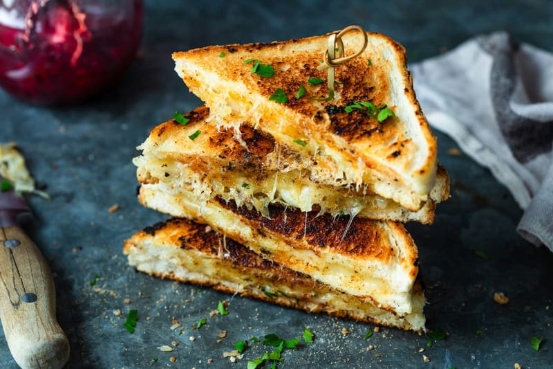 stacked toasted sandwiches with herbs
