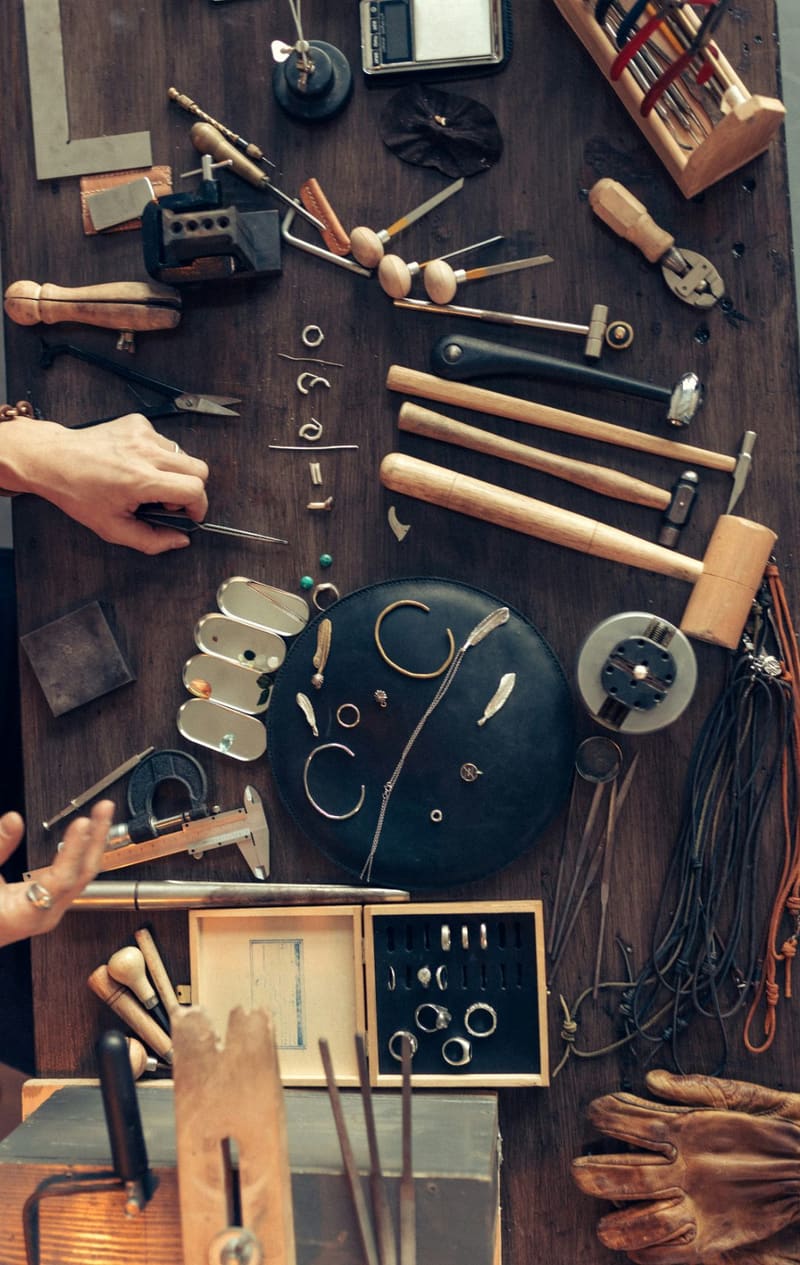 a jewellers bench of tools and rings