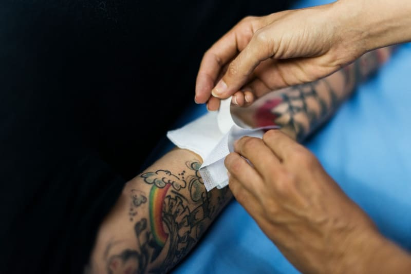 a fresh tattoo being wiped