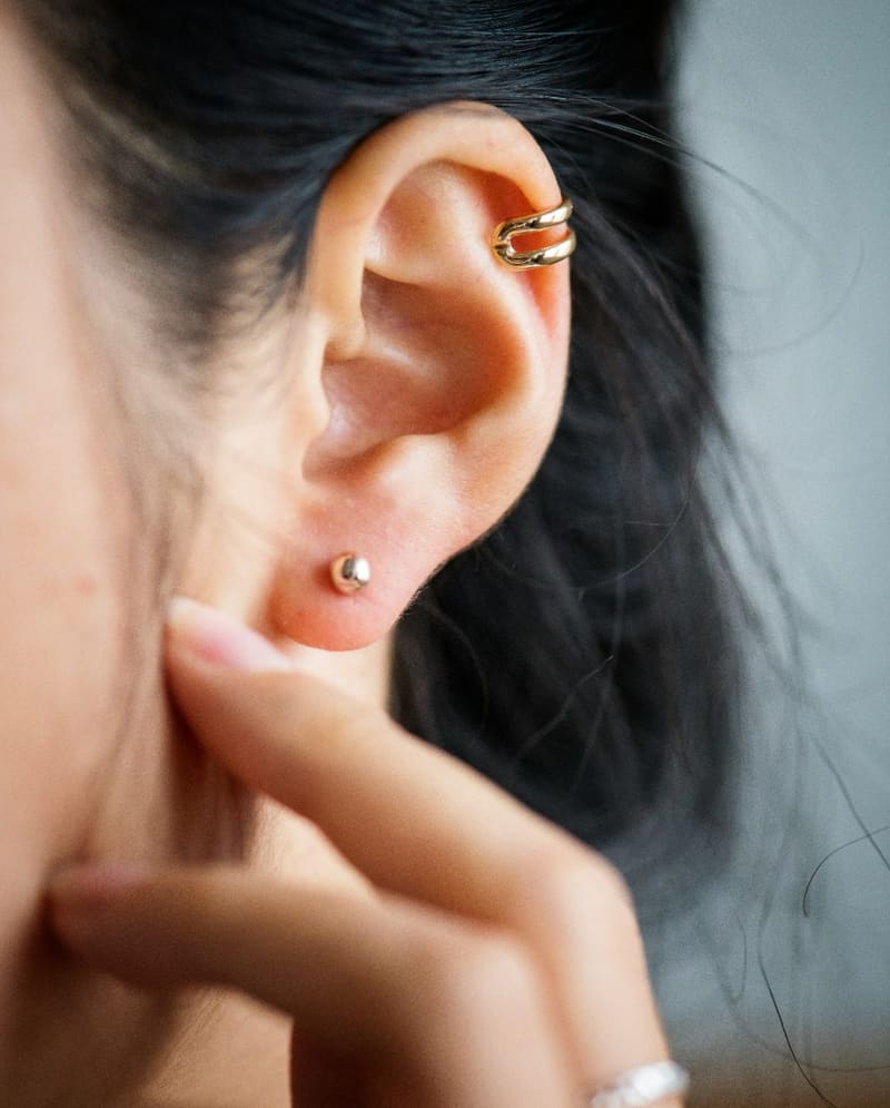 an ear with several piercings