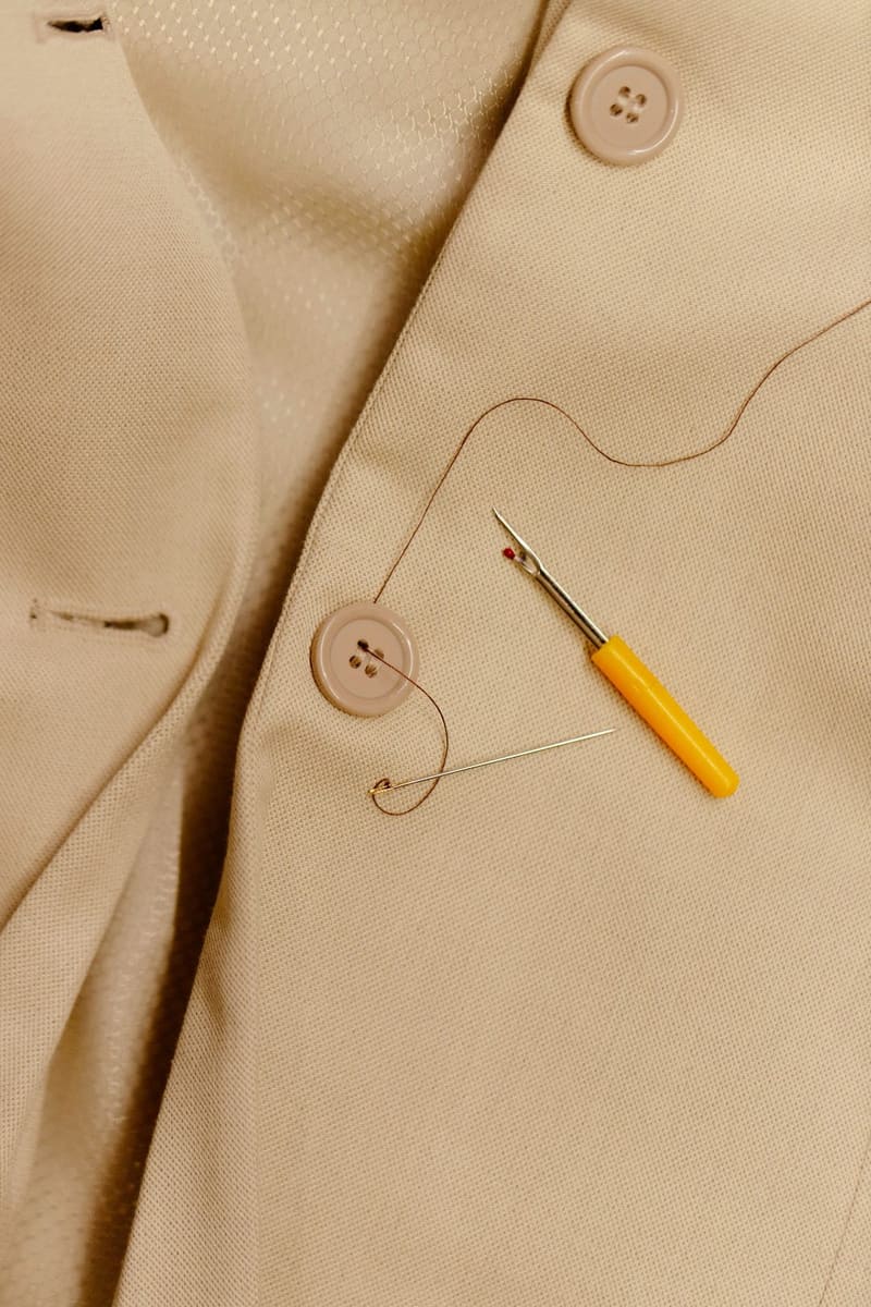 a needle and thread on a jacket button