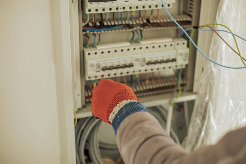 a hand at a consumer unit