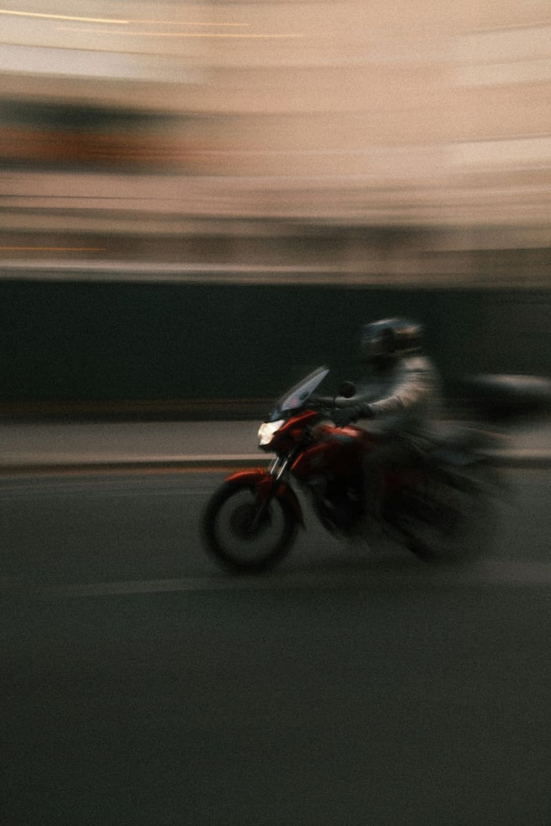 a motorcyclist blurred at speed