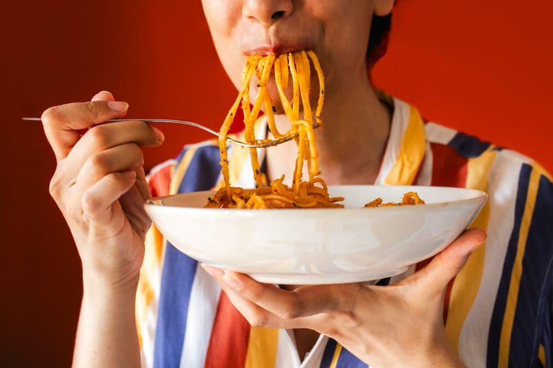 eating noodles from a bowl