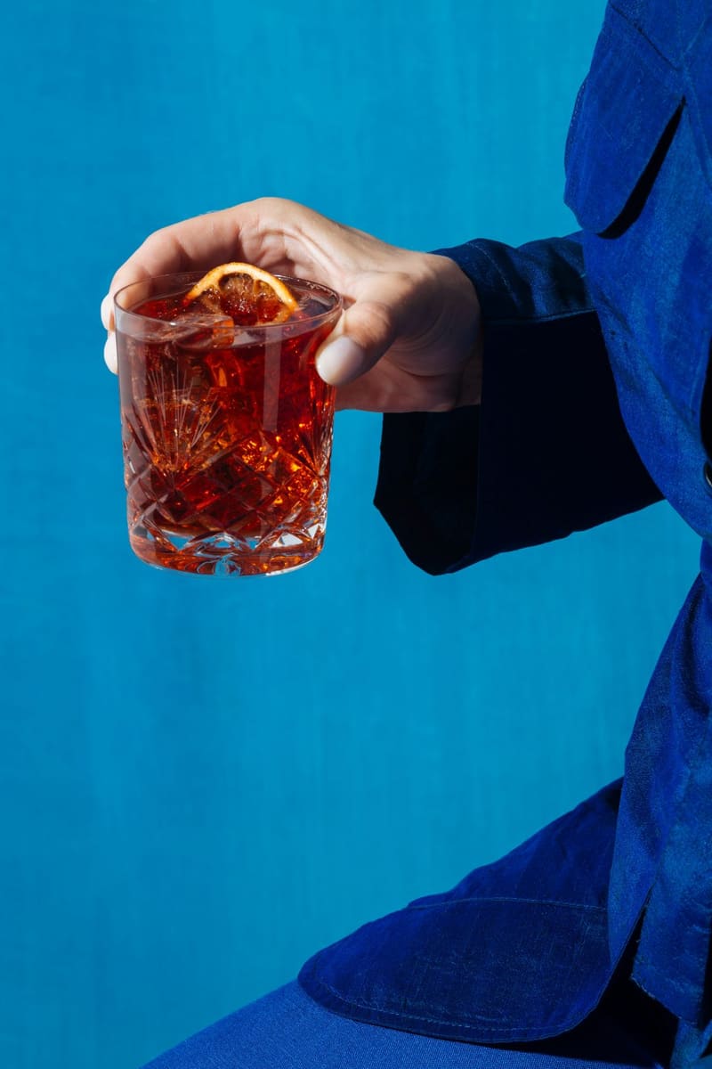 a negroni held against blue