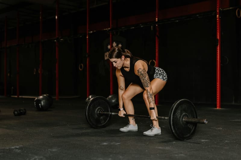 a woman lifting a loaded barbell