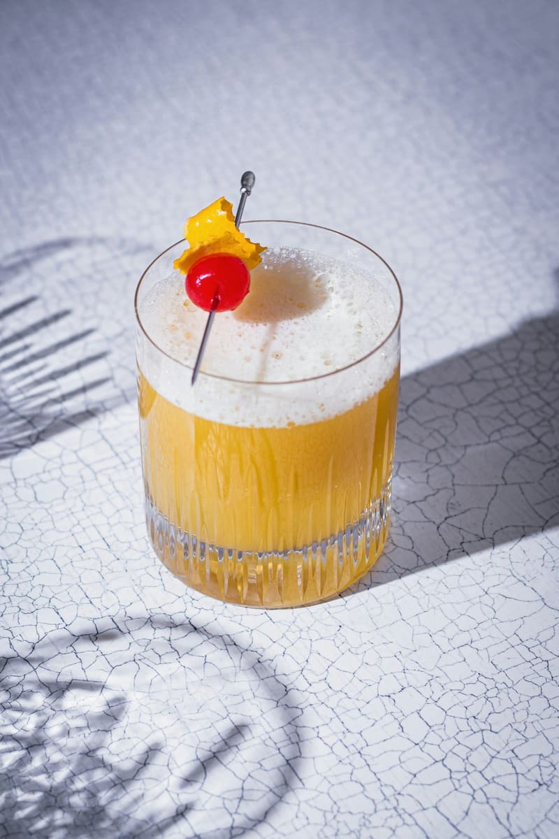 a whisky sour with a cherry
