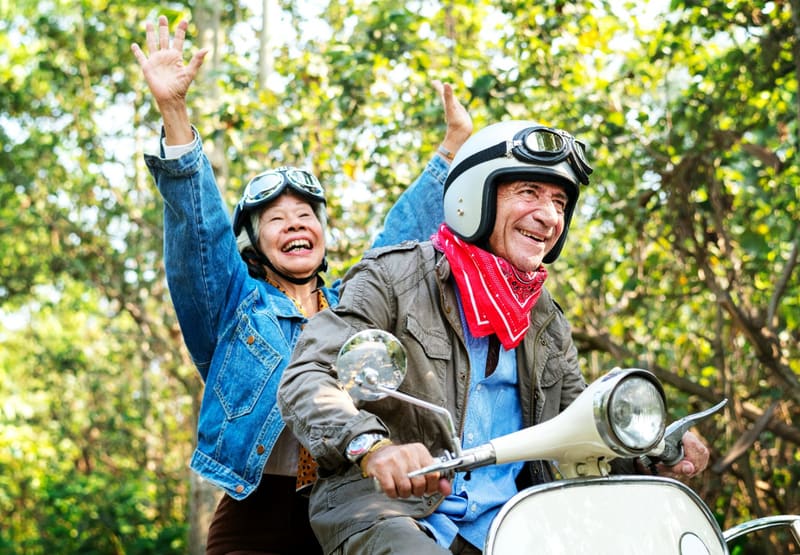 an older couple on a scooter