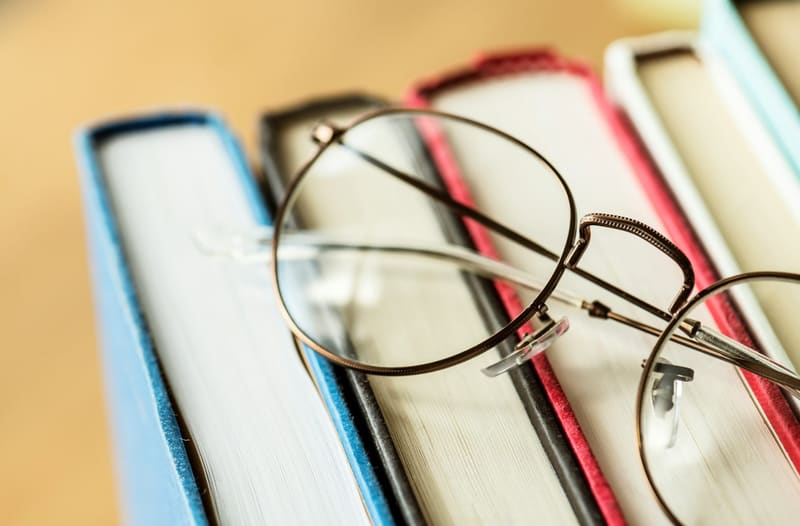 glasses resting on books