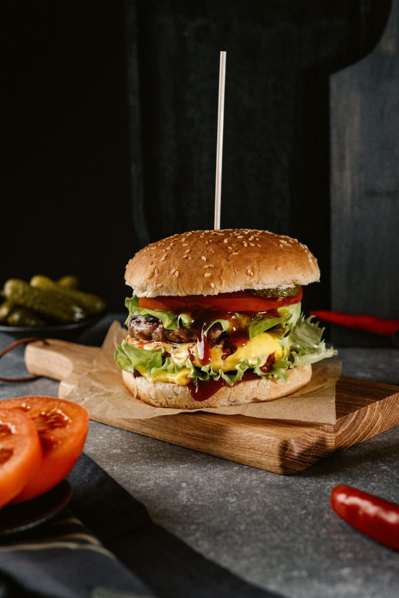 a burger on a wooden board