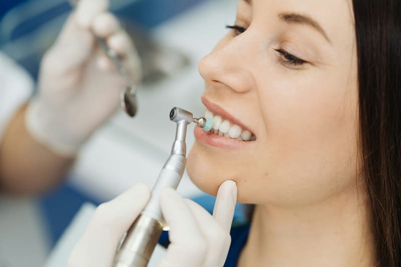 a dentist polishing a patient teeth