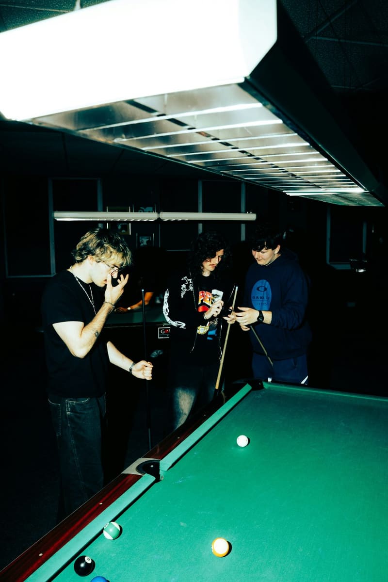 people playing pool in a dark bar