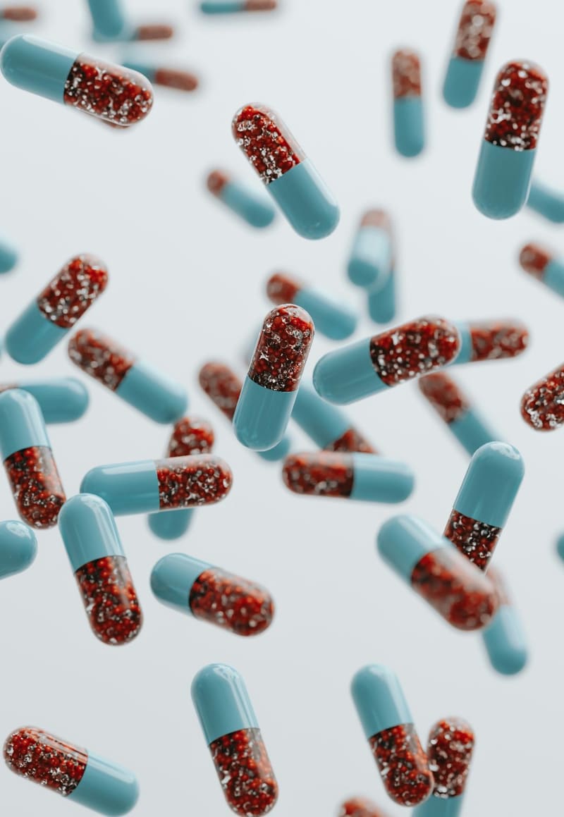 capsules falling against white