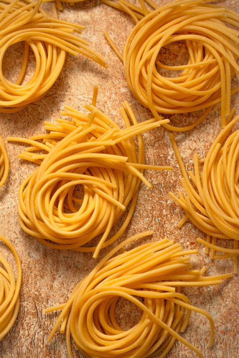 nests of spaghetti on a board