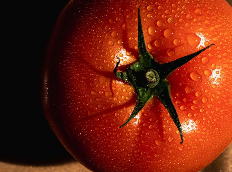 a tomato with water drops