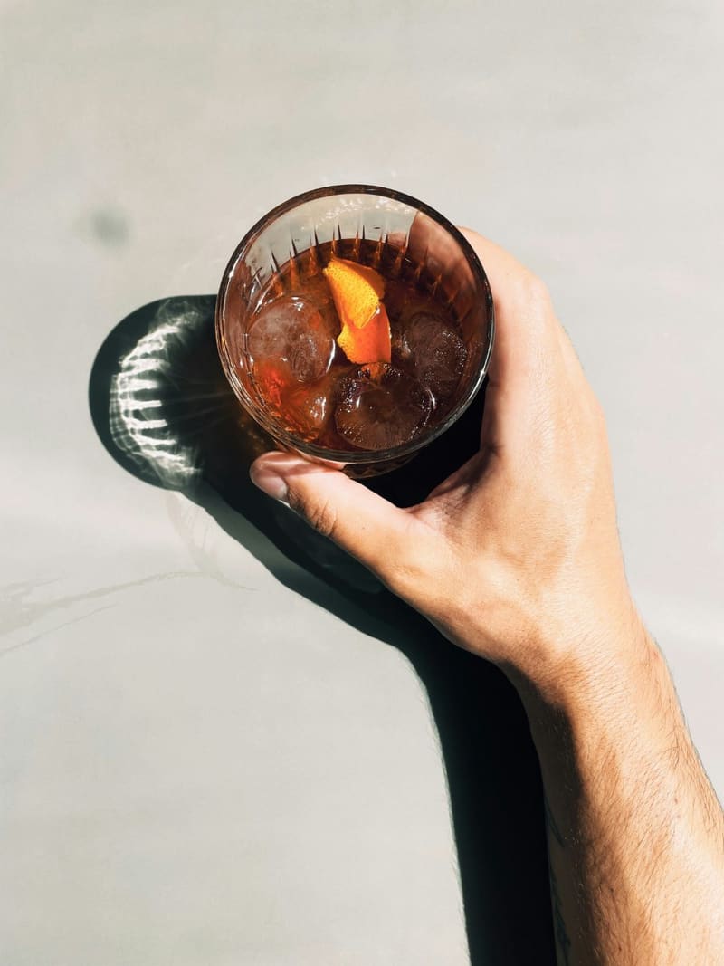 a hand holding an old fashioned