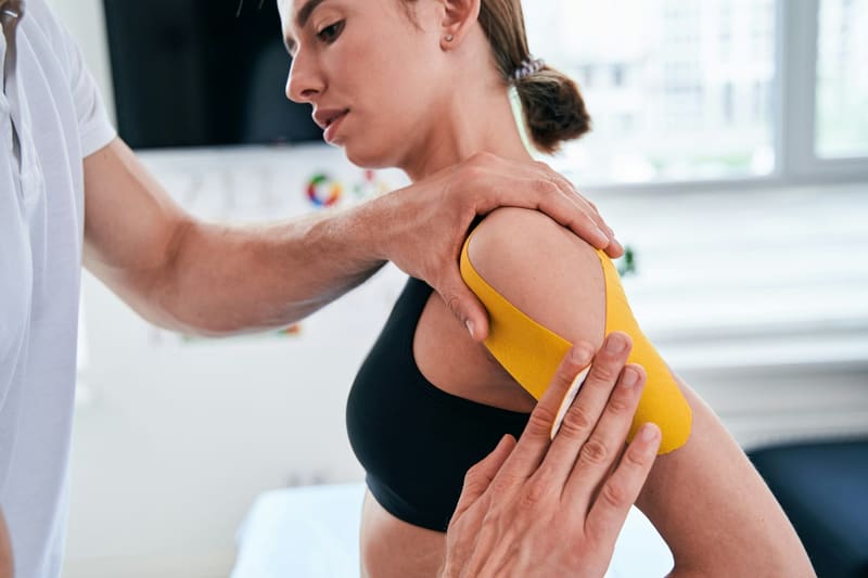 taping a shoulder in a clinic
