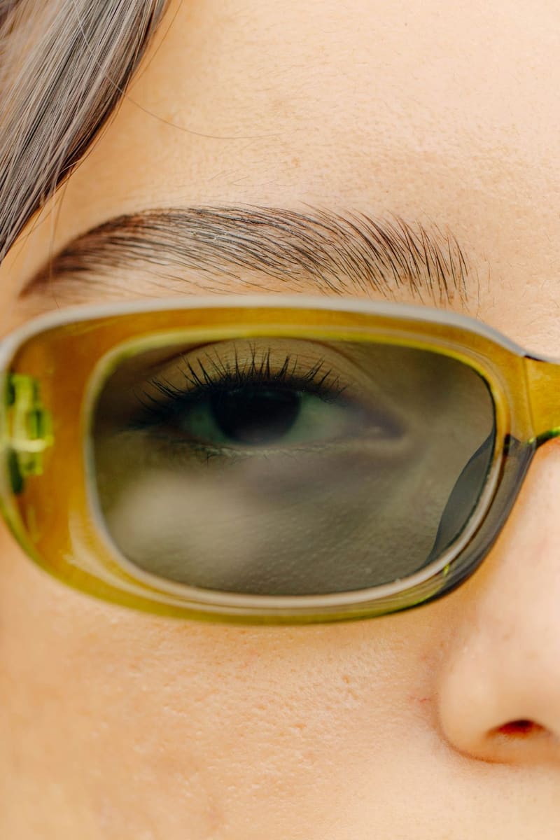 an eye behind tinted sunglasses